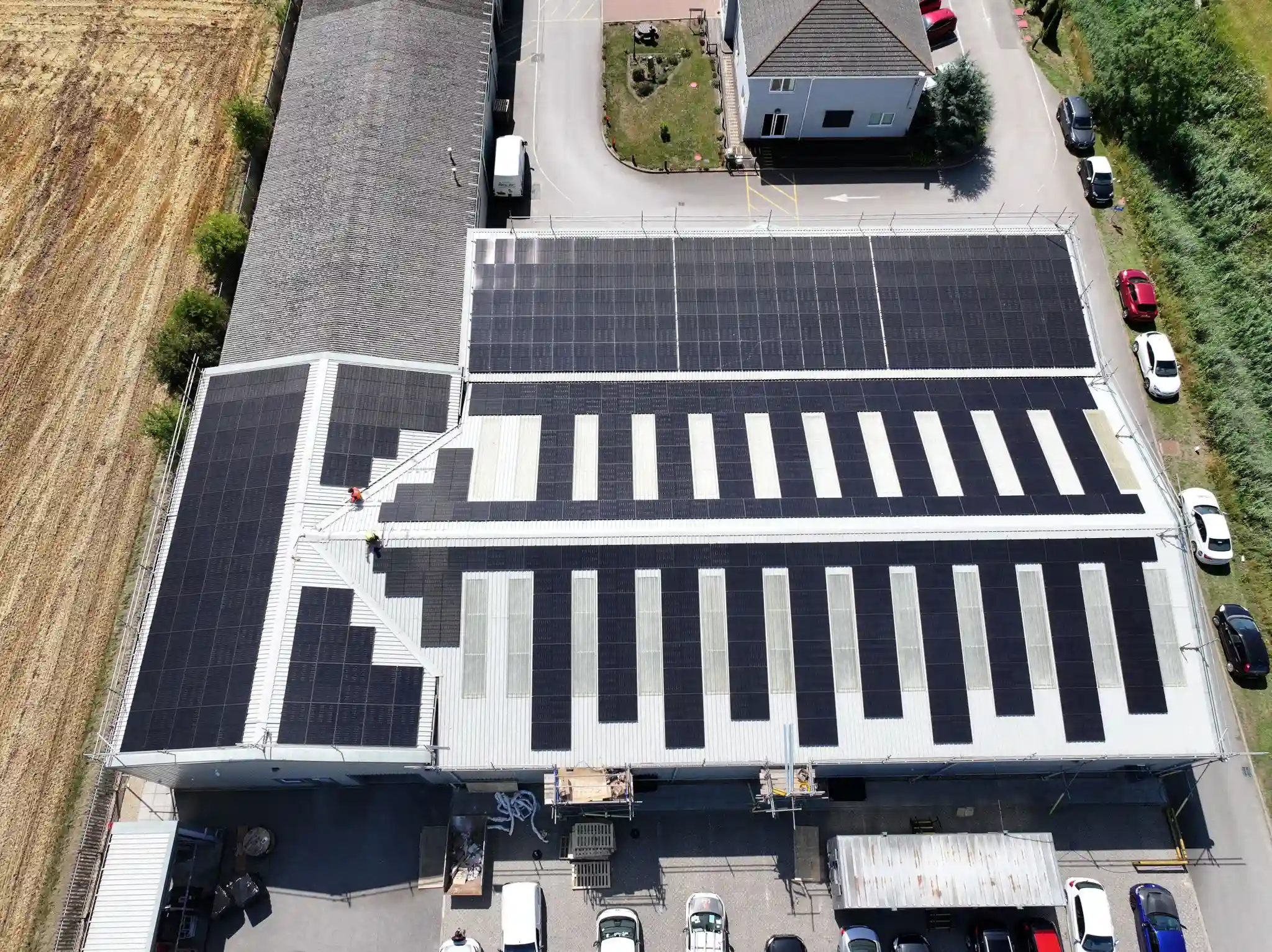 Aerial view of a commercial roof fully covered in solar panels